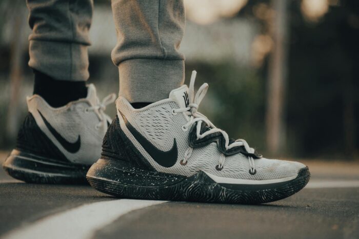 Stylish Nike sneakers on an asphalt road, perfect for sports and casual wear.